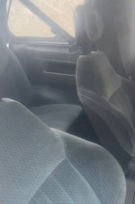 Interior view of a 1989 Suzuki Sidekick with gray seats and simple dashboard design.