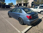 2008 Subaru Impreza WRX in blue, parked with 65,000 miles, available as a mechanic's special with rod knock.