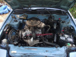 Under the hood of a 1987 Nissan Pulsar NX showing the engine and various components.