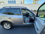 2007 BMW X3 3.0si AWD SUV with open doors, showcasing the spacious interior and exterior design.