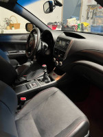 Interior view of a 2012 Subaru Impreza WRX STI with leather seats and manual gear shift.
