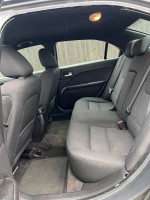 Interior view of a 2010 Ford Fusion showing comfortable back seat and starry ceiling.
