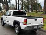 2005 GMC Sierra 2500 HD extended cab pickup truck in white, showcasing its clean exterior and original condition.