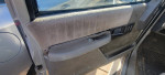 Interior door panel of a 1992 Chevrolet 2500 extended cab truck for sale, featuring power window controls.