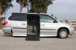 Silver Dodge Grand Caravan wheelchair mobility van with electric ramp and lowered floor, showcasing accessibility features.