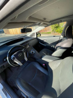 Interior view of a well-maintained 2011 Toyota Prius with leather seats and modern features.