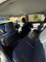Interior view of a 2011 Toyota Prius Hybrid featuring spacious leather seats and a sleek design.