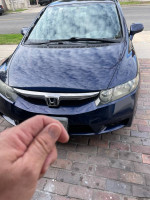 Front view of a blue 2009 Honda Civic LX with keyless entry and low mileage for sale.
