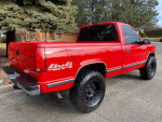 1997 GMC Sierra 1500 SL 4x4 red truck with matte black wheels parked outdoors