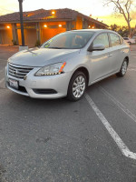 2014 Nissan Sentra S FWD in silver, showing maintained condition and clean exterior, ideal for fuel efficiency.