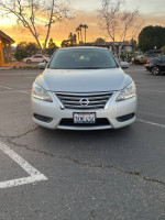 Front view of a well-maintained 2014 Nissan Sentra S in a parking lot during sunset