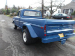 Blue 1972 Ford F-250 Camper Special dually parked on a street with collector plates.