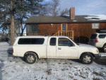 Used 2001 Toyota Tacoma Xtracab in white, 135,000 miles, manual transmission, excellent condition, ideal for road trips.