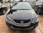 2014 Honda Civic EX-L in black with salvage title parked, featuring modern design and safety cameras.