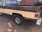 Side view of a vintage 1977 GMC C-35 Sierra classic pickup truck with noticeable rust and features