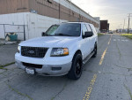 2003 Ford Expedition XLT FX4 4WD with 85,000 miles parked on the street, showcasing its sleek design and black wheels.
