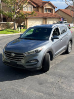 2016 Hyundai Tucson in great mechanical condition with some scratches, parked on a residential street.