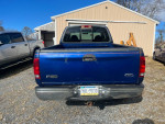 1998 Ford F150 extended cab 4X4 for sale, blue color with minor scratches and a tweaked rear bumper