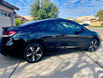 2014 Honda Civic EX Coupe in black, showcasing sleek design and alloy wheels, parked on a driveway.